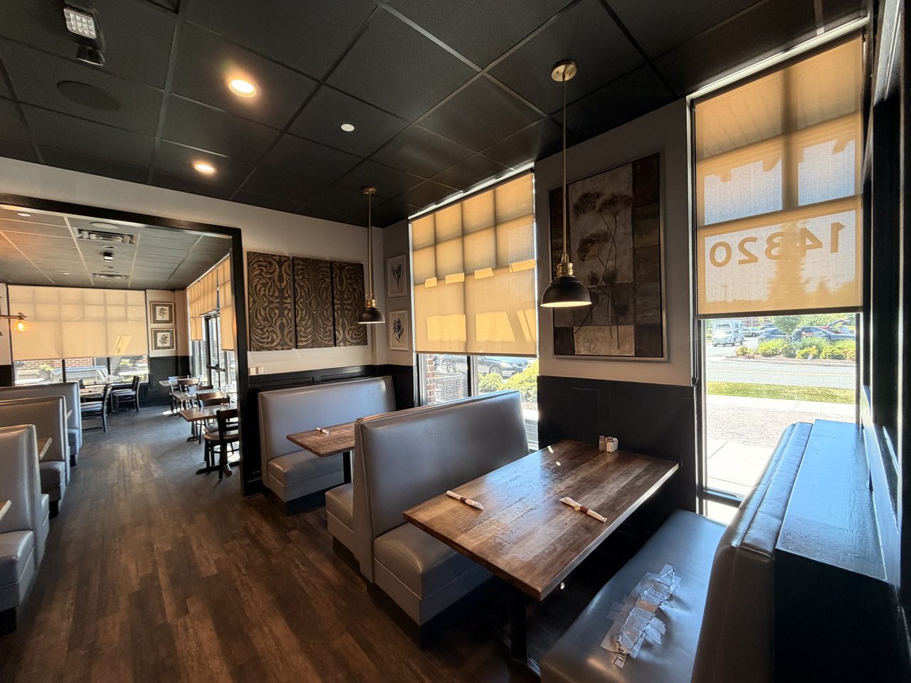 Booths against a stone wall under warm pendant lighting