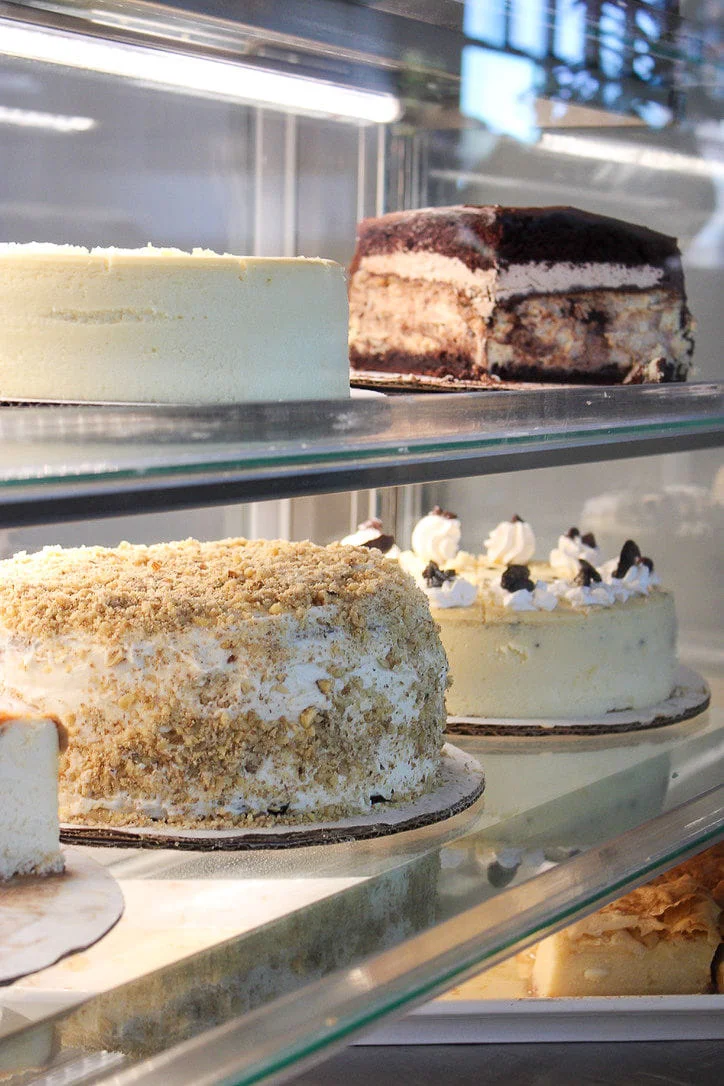 Effie's pastry case stocked with full cheesecakes and tower cakes
